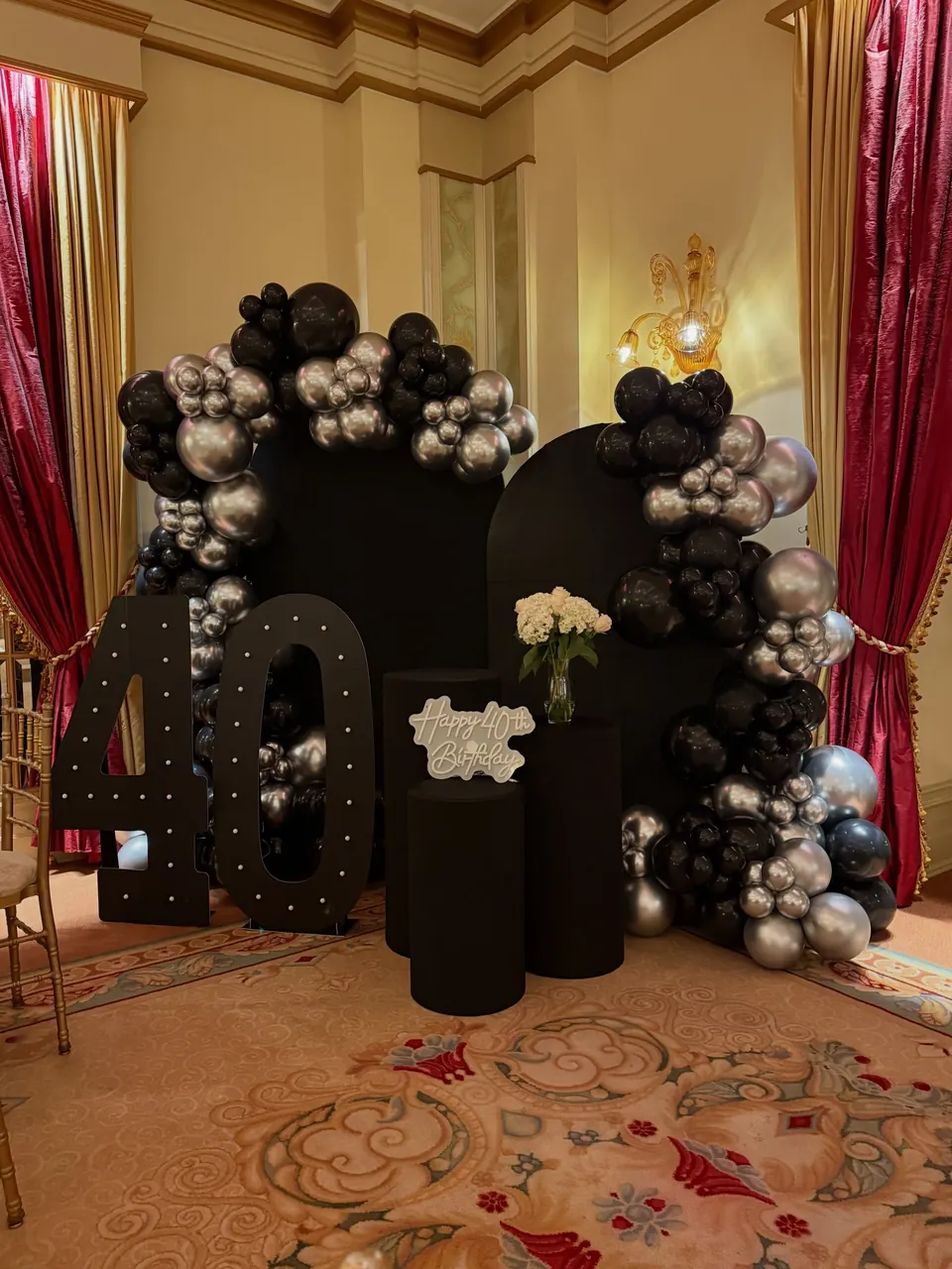 Black and chrome garland around black arches with a big number 40